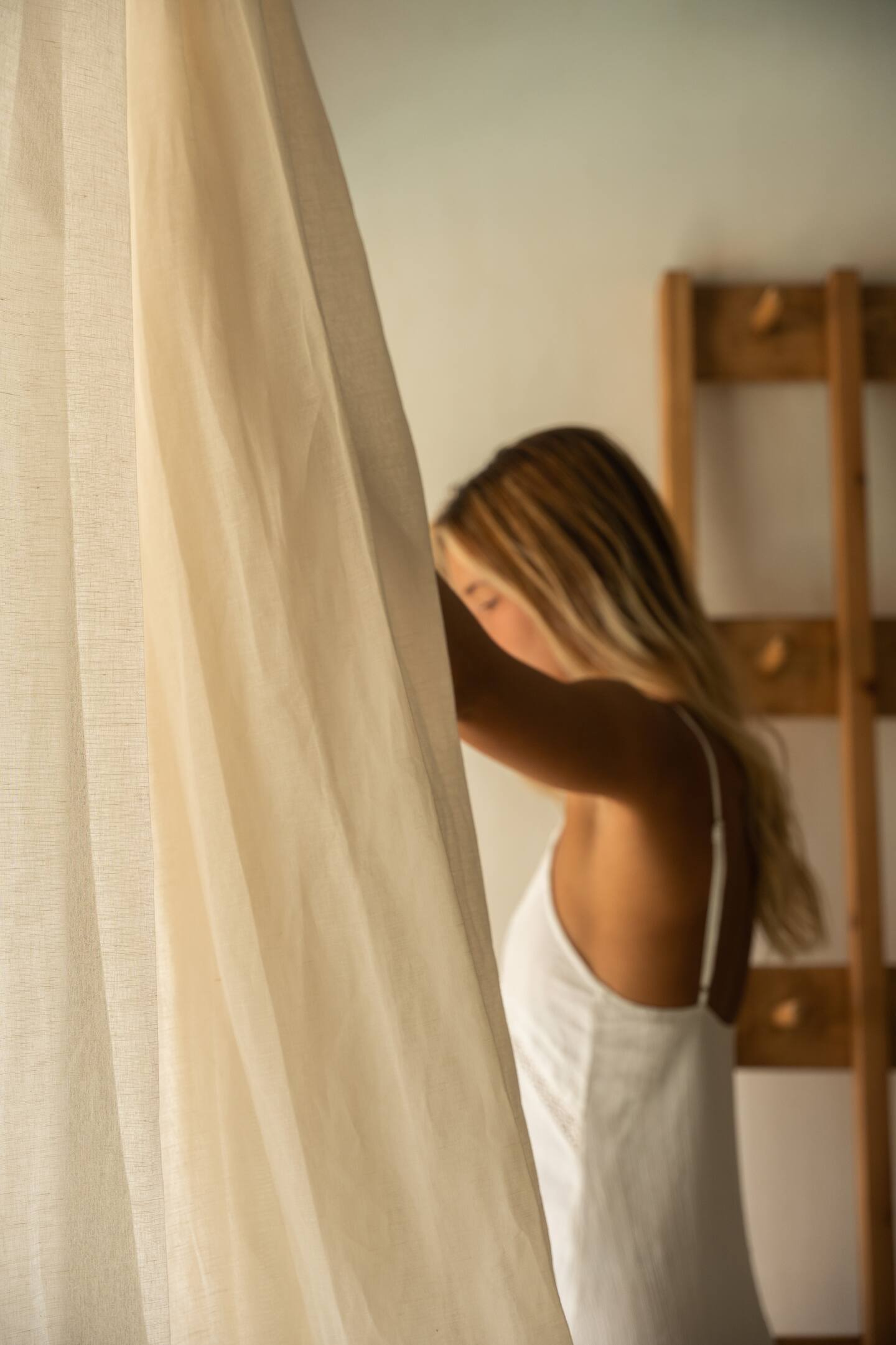 Sheer linen curtain catching morning light at Theta Skyros, Skyros, Greece