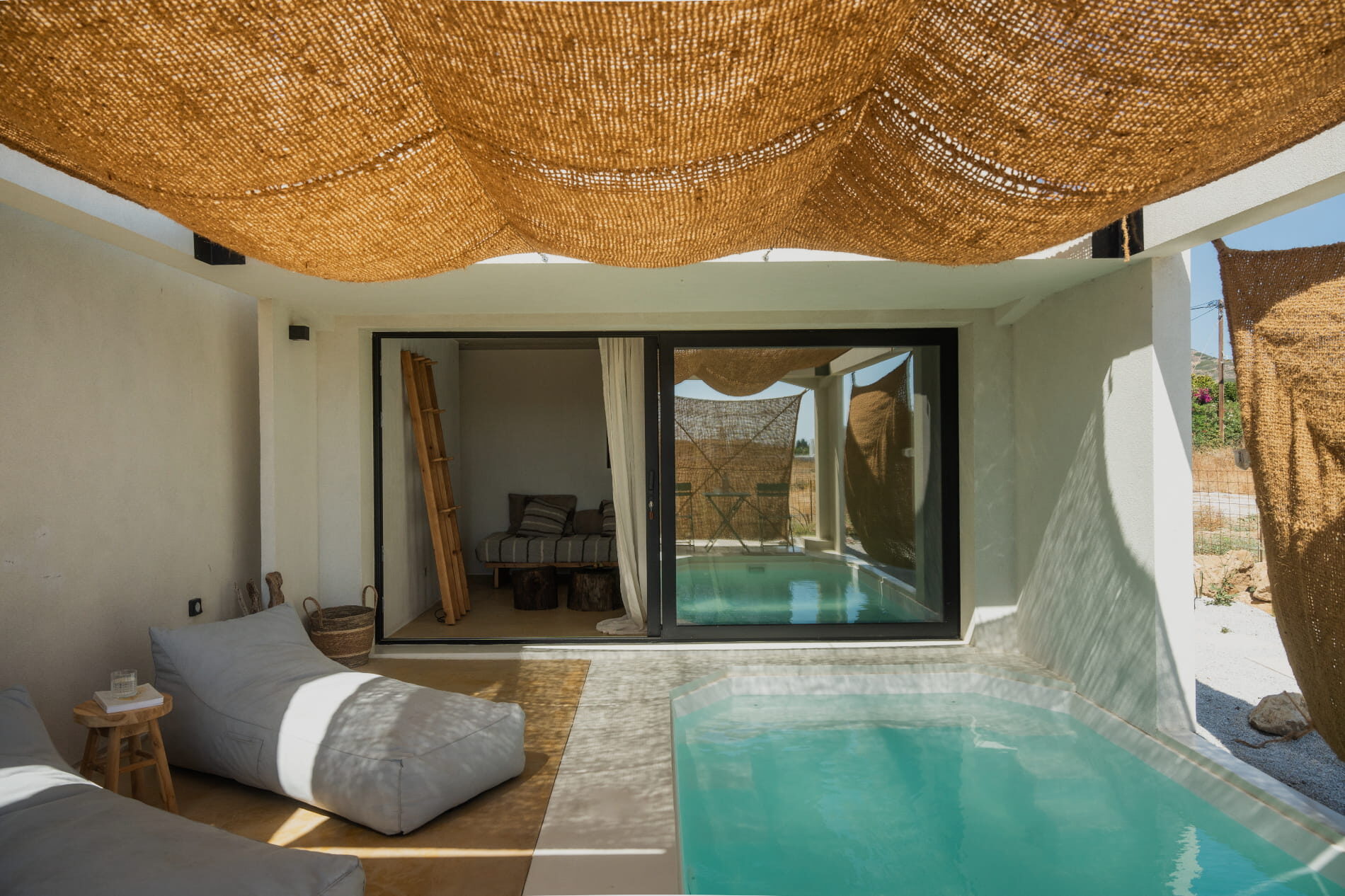 Theta Skyros — private pool under a hand-woven jute canopy, with linen lounger, Skyros, Greece